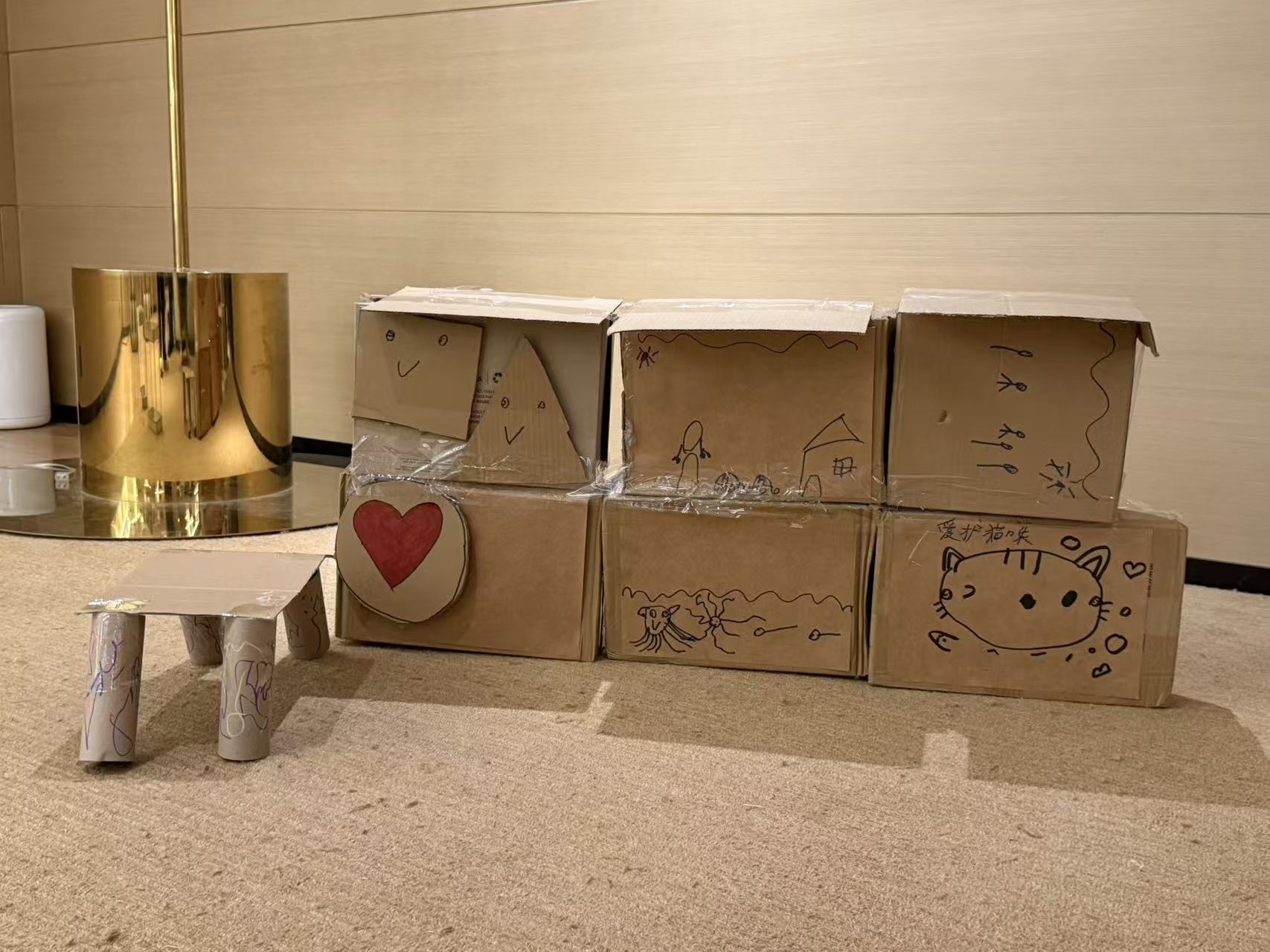 The decorated front of a structure assembled from cardboard boxes.
