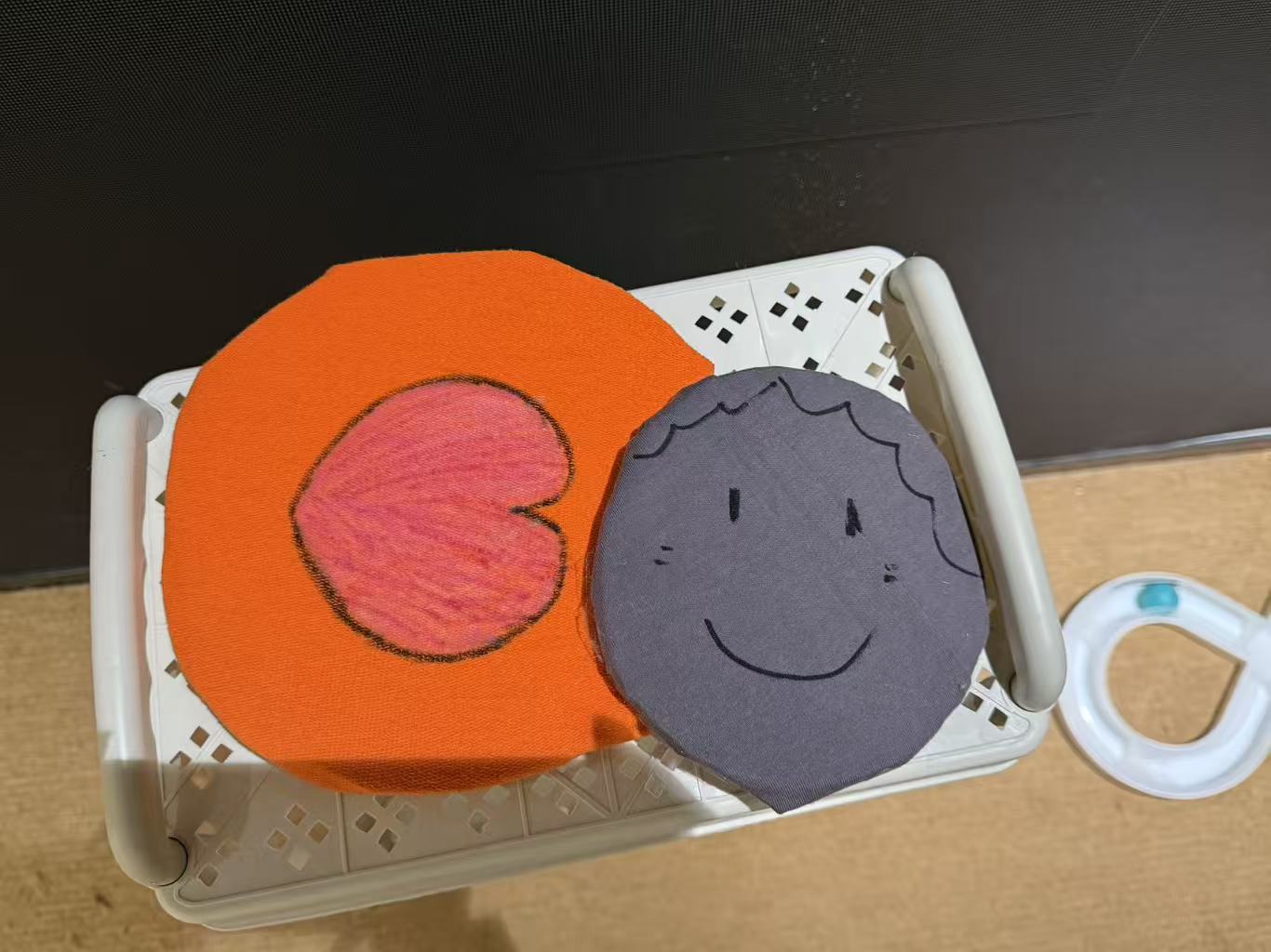 Round play discs decorated with a heart and a smiling face.