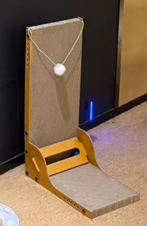 Actual scratching board with horizontal and vertical surfaces and a hanging ball.